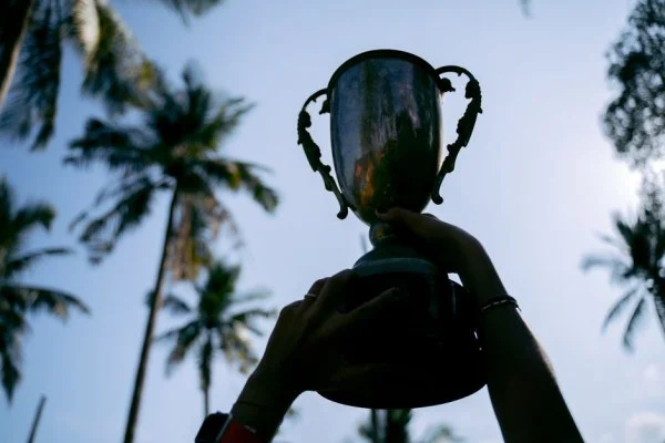 champion holding trophy